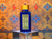 photo of 25ml sapphire blue bottle with gold toned lid and gold engraved plate of  poivre saphir