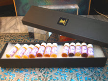 another group photo of discovery set of 12 original silver eNVie collection perfume oils in 2ml in a long black box.  No inserts.