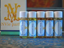 another group photo of small blue box sampler that includes all five new Silver Collection perfume oils in 2ml.  Ruby saphir, lazuli saphir, emerald saphir, dream amethyst saphir and pink saphir