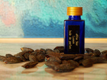 photo of 25ml sapphire blue bottle with gold lid and black engraved plate of Lyceum