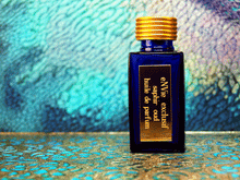 photo of 25ml sapphire blue bottle with gold toned lid and gold engraved plate of saphir oud