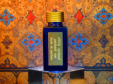 photo of 25ml sapphire blue bottle with gold toned lid and gold engraved plate of patchouli noir