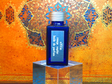 photo of 25ml sapphire blue bottle with silver lid and silver engraved plate of rouge saphir